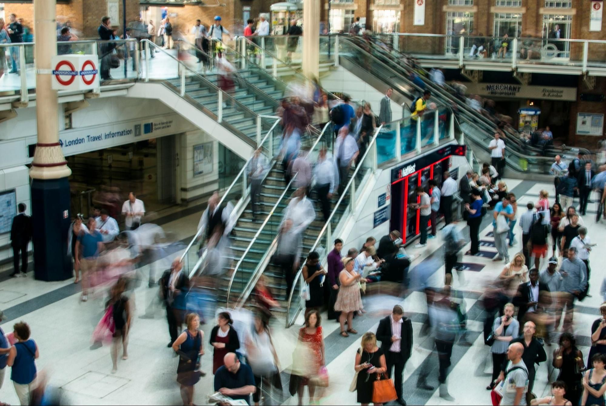 People moving through a busy transportation hub