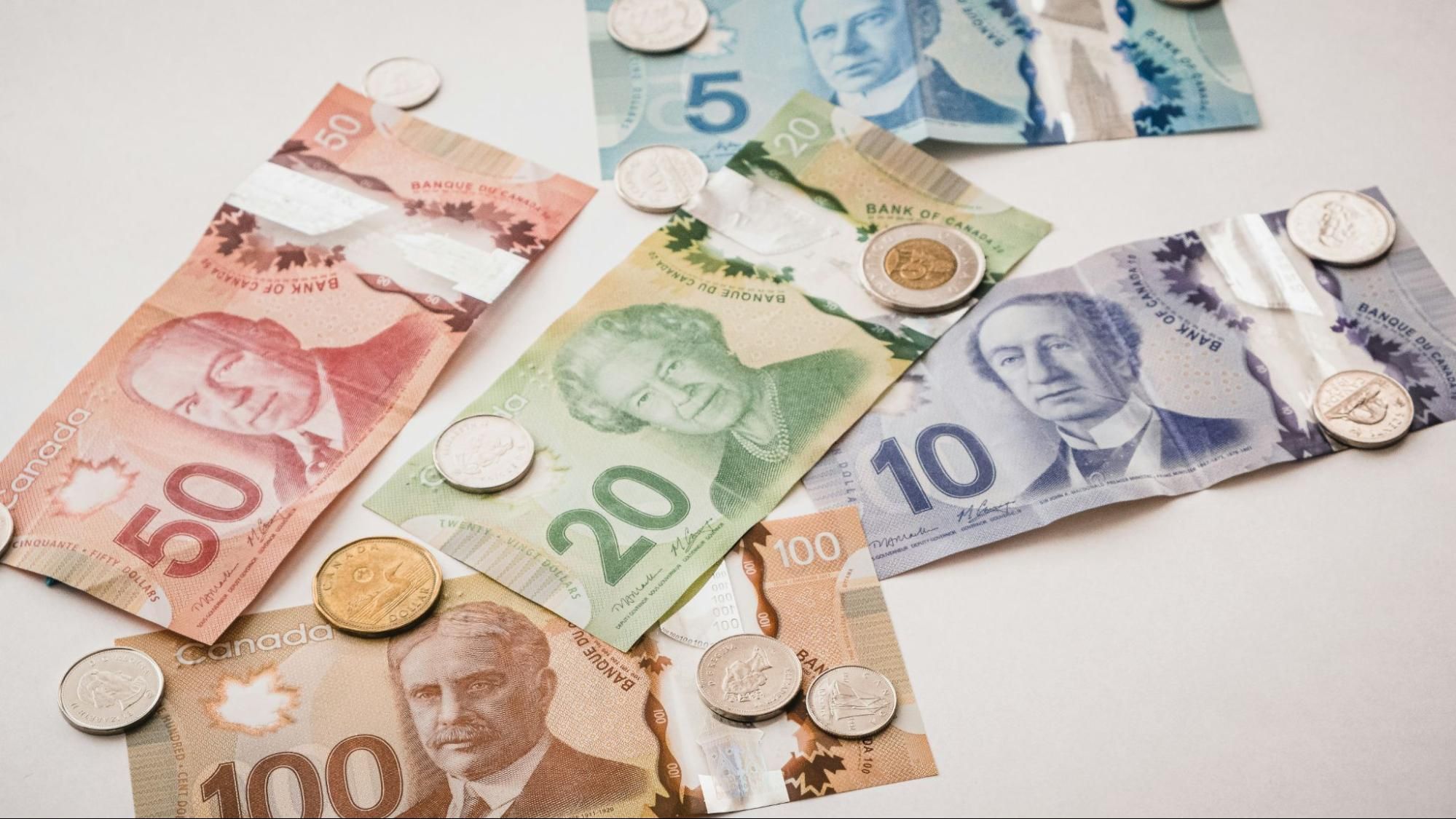 A pile of Canadian currency including bills and coins.