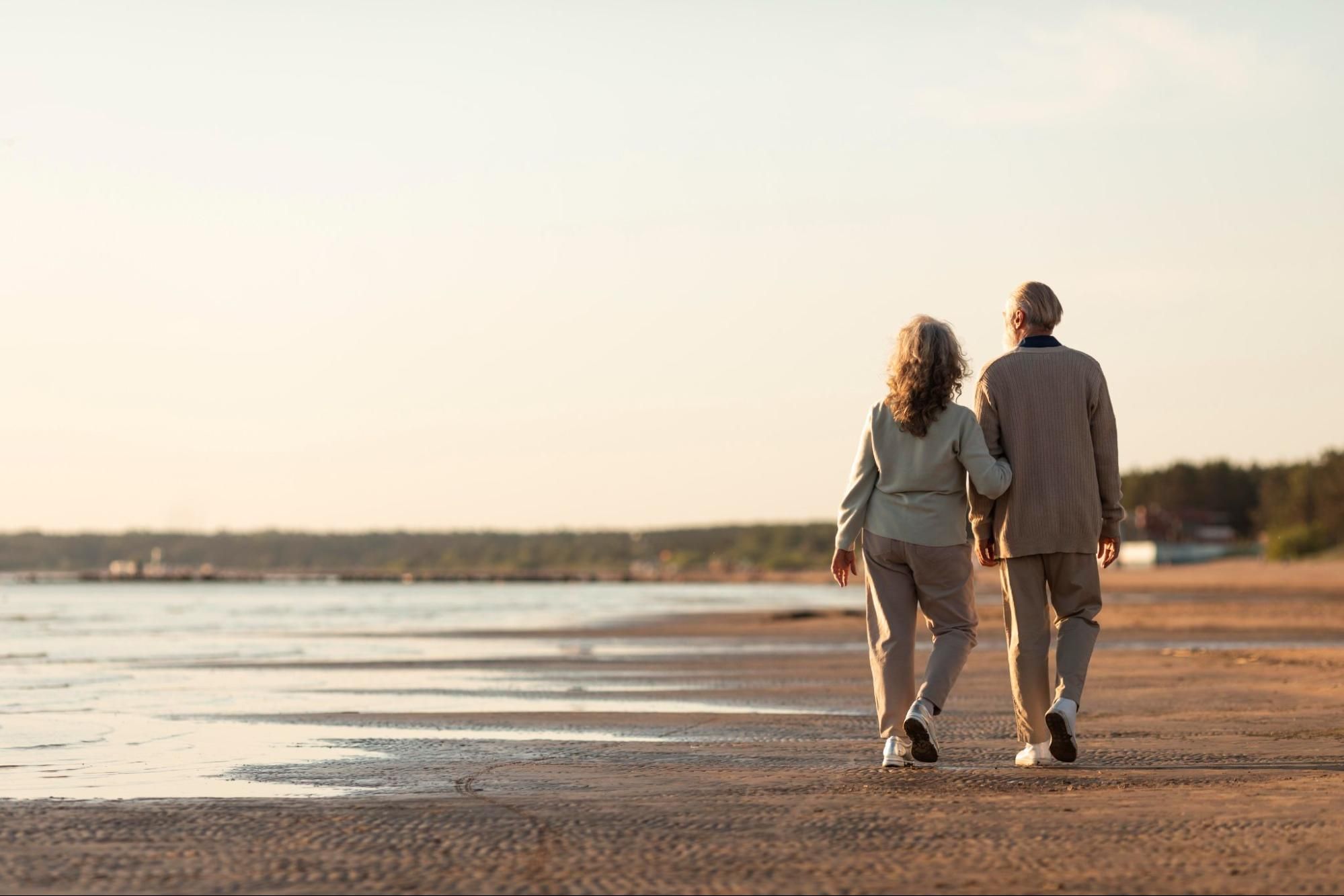 Retired Couple Taking a Stroll on the Beach
